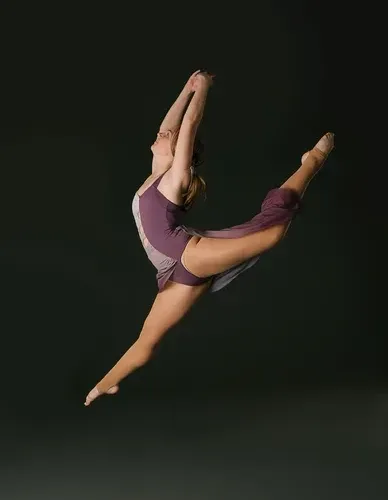 Contemporary dancer leaping with dramatic pose